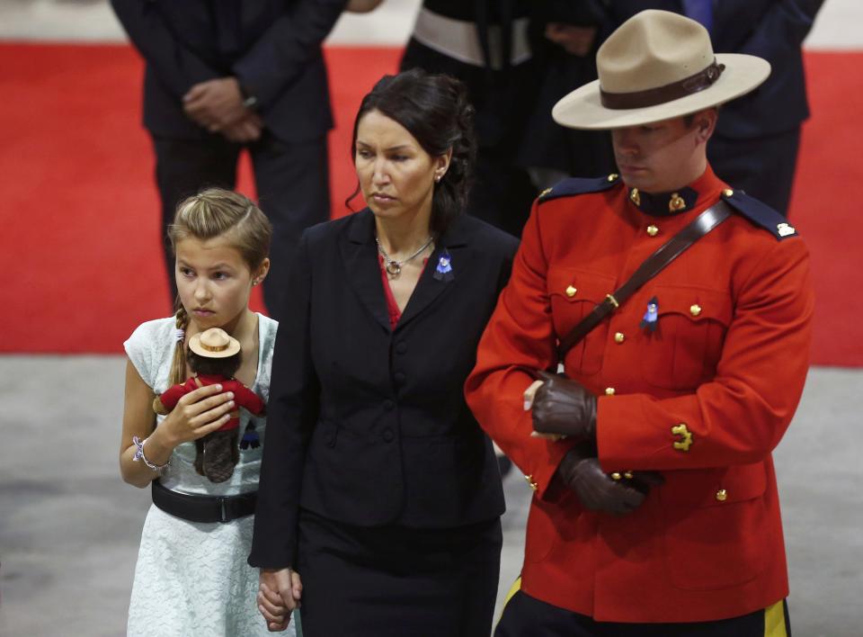 Family members arrive at the regimental funeral for three Royal Canadian Mounted Police officers who were killed last week in Moncton