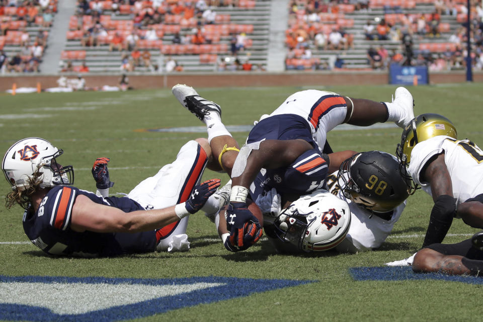 Auburn running back Sean Jackson (44) stretches over the goal line for a touchdown as Alabama State lineman Joshua Long (98) defends during the second half of an NCAA football game Saturday, Sept. 11, 2021, in Auburn, Ala. (AP Photo/Butch Dill)