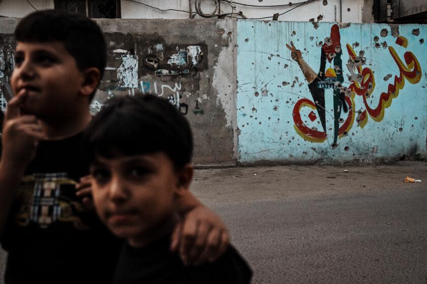 JENIN, OCCUPIED WEST BANK -- OCTOBER 18, 2023: Children play on the streets in the refugee camp in Jenin, Occupied West Bank, Wednesday, Oct. 18, 2023. Amid the confrontation between Israel and Hamas, Palestinians rage against another target: Their own rulers, who they see as weak and impotent before Israel's offensive in Gaza and escalating settler violence in the occupied West Bank. (MARCUS YAM / LOS ANGELES TIMES)