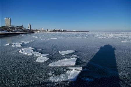 The shadow of a light house is seen in the frozen waters of the port of Milwaukee as another round of arctic air blasts the midwest, keeping the wind chill in the negative numbers, in Milwaukee, Wisconsin February, 6, 2014. REUTERS/Darren Hauck