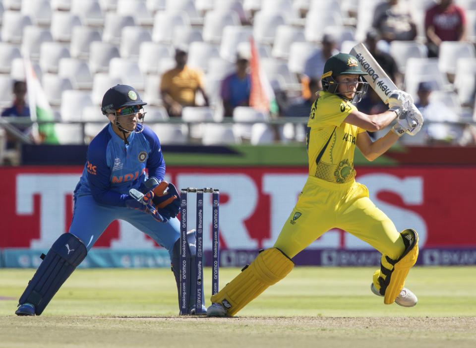 Australia's Meg Lanning in action while India's Richa Ghosh looks onduring the Women's T20 World Cup semi final cricket match in Cape Town, South Africa, Thursday Feb. 23, 2023. (AP Photo/Halden Krog)