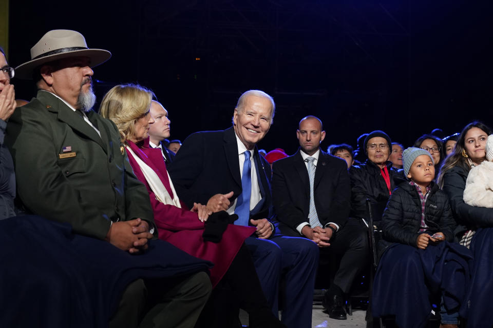 President Joe Biden and first lady Jill Biden watch performers after they lit the National Christmas Tree on the Ellipse, near the White House, Thursday, Nov. 30, 2023, in Washington. (AP Photo/Andrew Harnik)