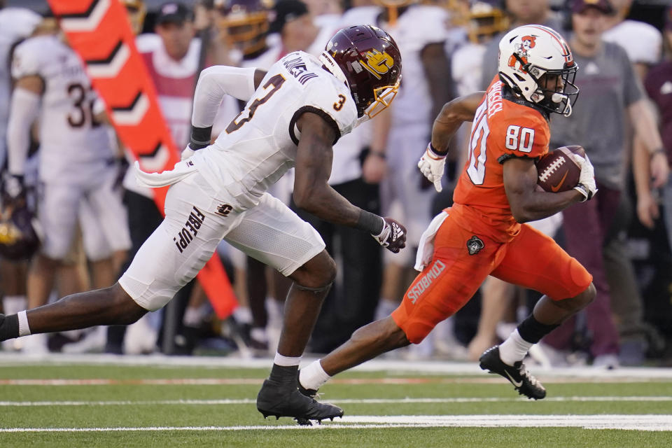 Oklahoma State wide receiver Brennan Presley (80) is chased by Central Michigan defensive back Trey Jones (3) during the first half of an NCAA college football game Thursday, Sept. 1, 2022, in Stillwater, Okla. (AP Photo/Sue Ogrocki)