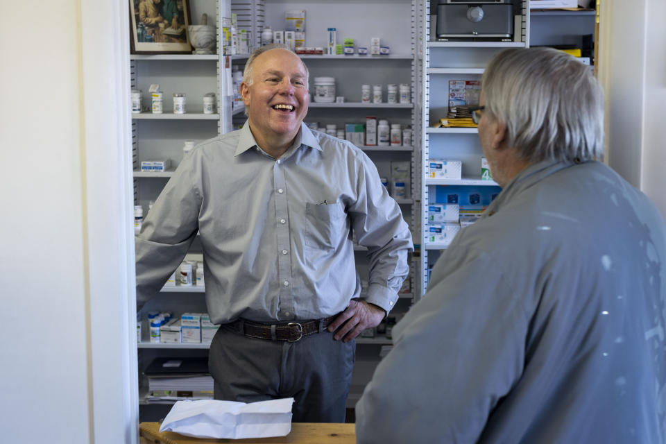 Craig Jones helps a patient at Basin Pharmacy in Basin, Wyo., on Wednesday, Feb. 21, 2024. (AP Photo/Mike Clark)