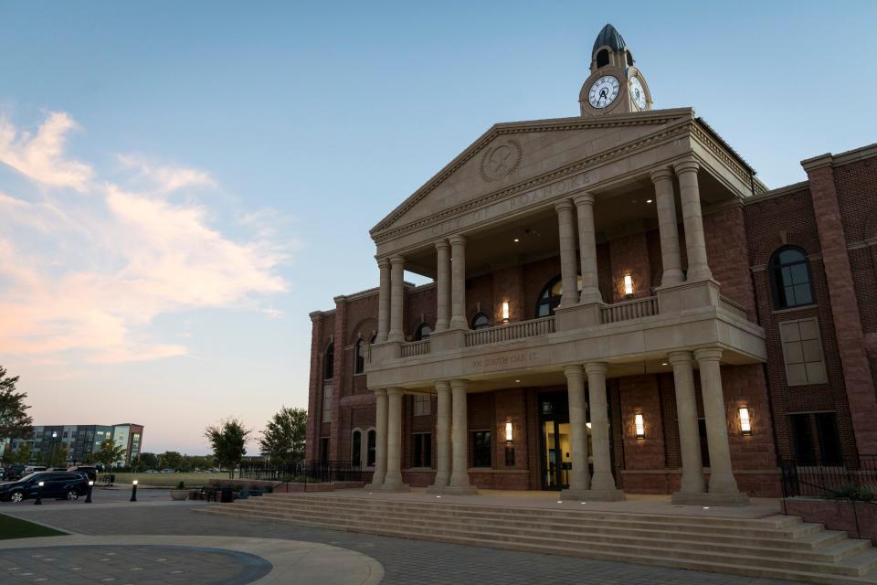 The sun sets over Roanoke City Hall in downtown Roanoke, Texas.