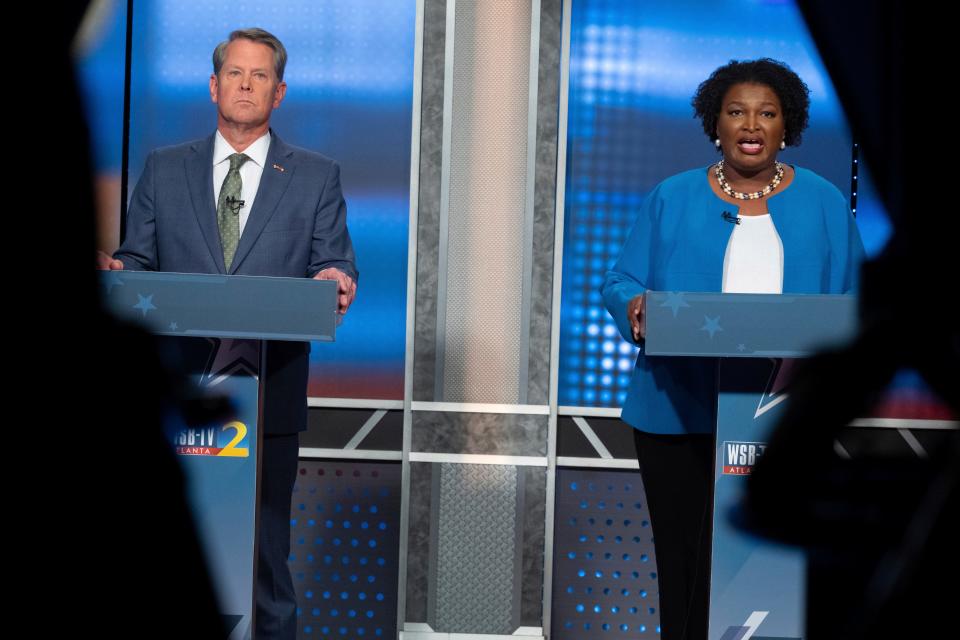 Republican Georgia Gov. Brian Kemp, left, and Democratic challenger Stacey Abrams face off in a televised debate, in Atlanta on Oct. 30.