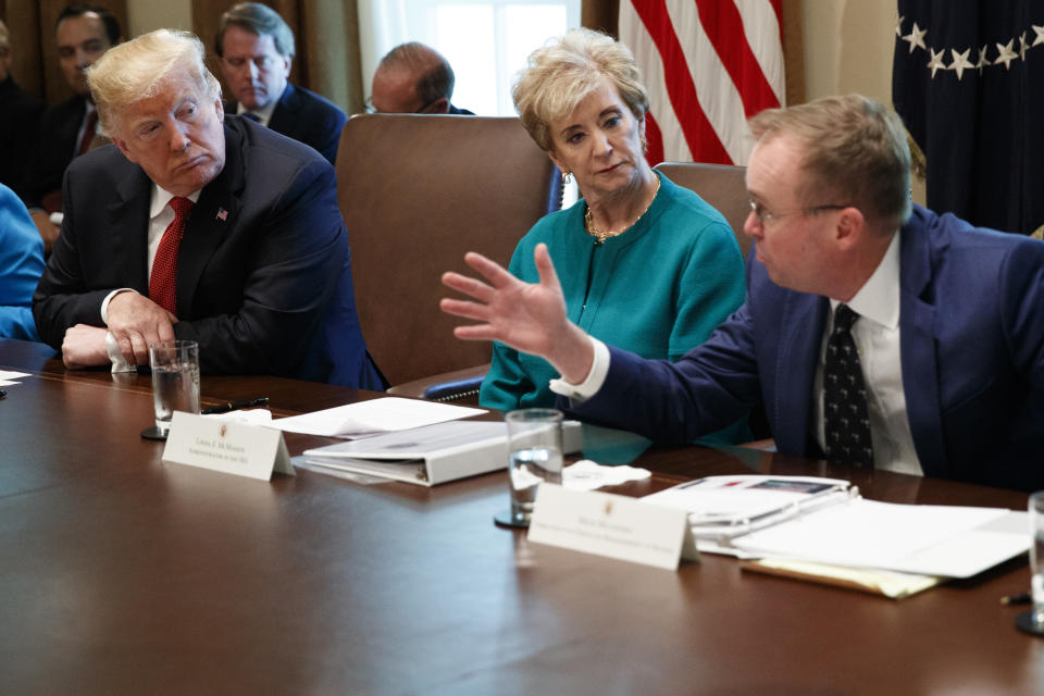 President Donald Trump, left, and Small Business Administration administrator Linda McMahon, center, listen as Director of the Office of Management and Budget Mick Mulvaney speaks during a cabinet meeting in the Cabinet Room of the White House, Wednesday, Oct. 17, 2018, in Washington. (AP Photo/Evan Vucci)