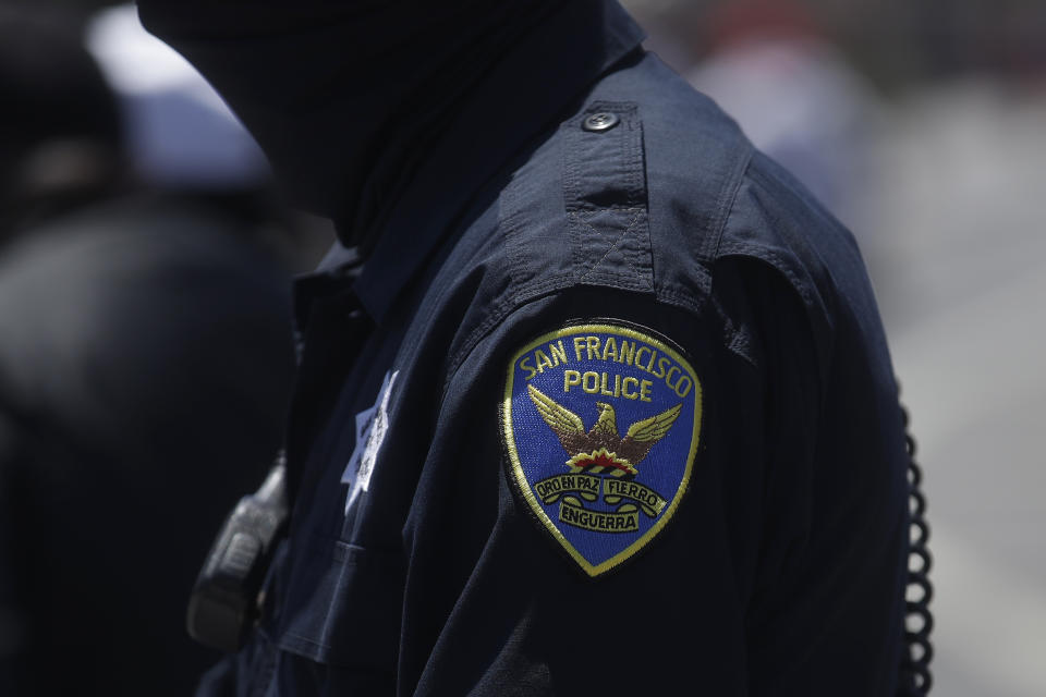 FILE - In this July 7, 2020, file photo a San Francisco Police Department patch is shown on an officer's uniform in San Francisco. Law enforcement agencies across the country experienced a wave of retirements and departures and are struggling to recruit the next generation of police officers in the year since George Floyd was killed by a cop. And amid the national reckoning on policing, communities are questioning who should become a police officer today. (AP Photo/Jeff Chiu, File)