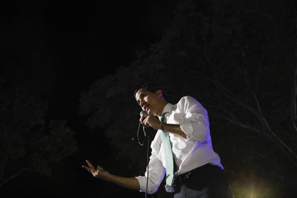 Venezuelan opposition leader and self-proclaimed interim president Juan Guaido speaks during a citizen's meeting in in Caracas, Venezuela, Wednesday, Nov. 13, 2019. Guaido is calling people across the crisis-torn nation to flood the streets for protests nearly a year since launching an urgent campaign to push President Nicolás Maduro from power. (AP Photo/Ariana Cubillos)