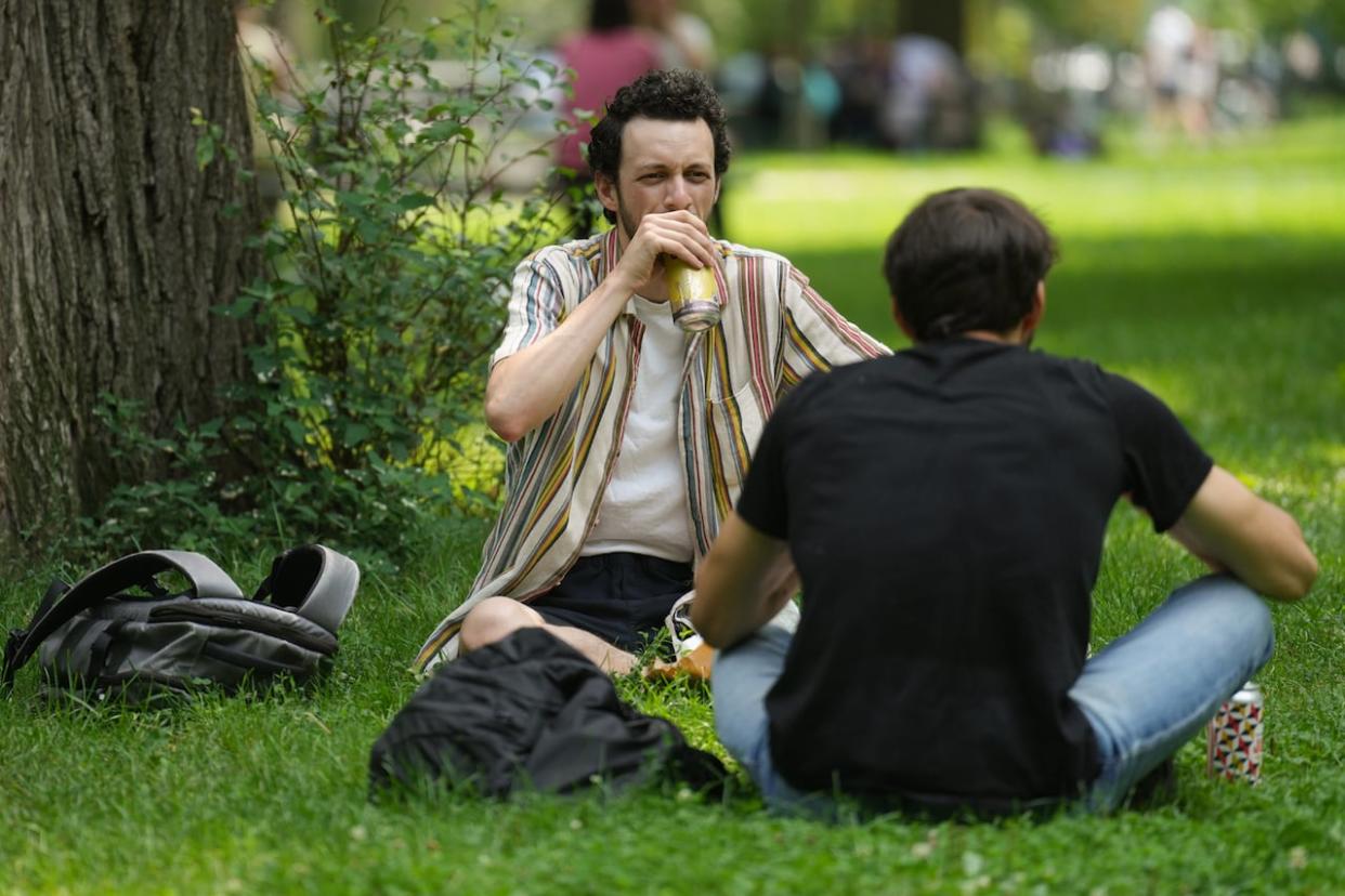 A man drinks a beer in Trinity Bellwoods Park in August 2023. (Chris Young/The Canadian Press - image credit)