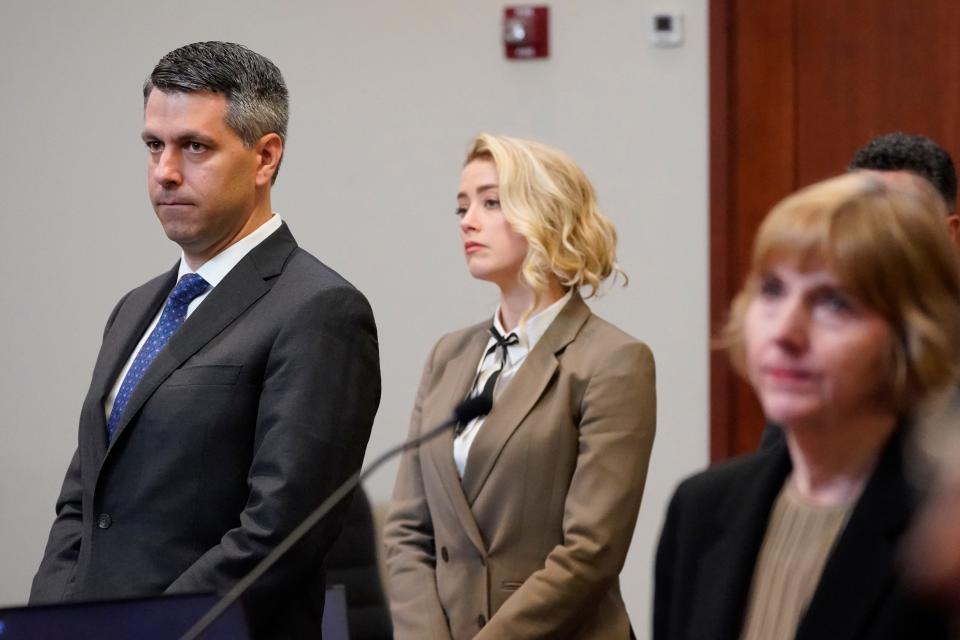 Amber Heard watches as the jury arrives into the courtroom after a break at the Fairfax County Circuit Courthouse in Fairfax, Virginia, on May 23, 2022.
