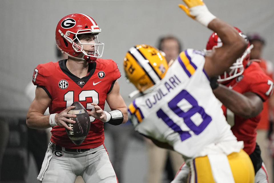 Georgia quarterback Stetson Bennett (13) sets back to pass in the first half of the Southeastern Conference championship NCAA college football game against LSU, Saturday, Dec. 3, 2022, in Atlanta. (AP Photo/Brynn Anderson)