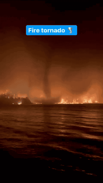 A fiery tornado seen from a water body with text overlay "Fire tornado"