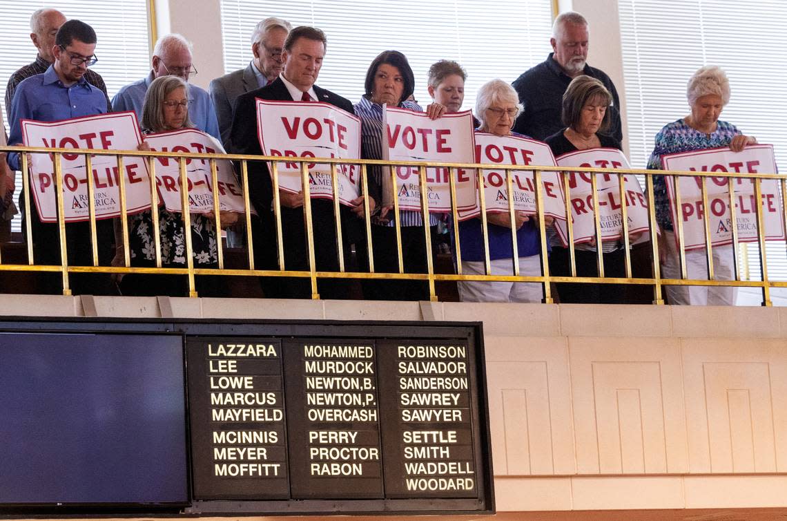 Supporters of a Senate vote to overturn Gov. Roy Cooper’s veto of an abortion restriction bill stand for an opening prayer in the Senate gallery Tuesday, May 16, 2023, at the Legislative Building in Raleigh, N.C. Senate Republicans voted to overturn the veto.