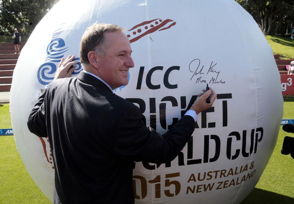 New Zealand Prime Minister John Key poses for pictures before the start of day one of the second international test cricket match between India and New Zealand in Wellington