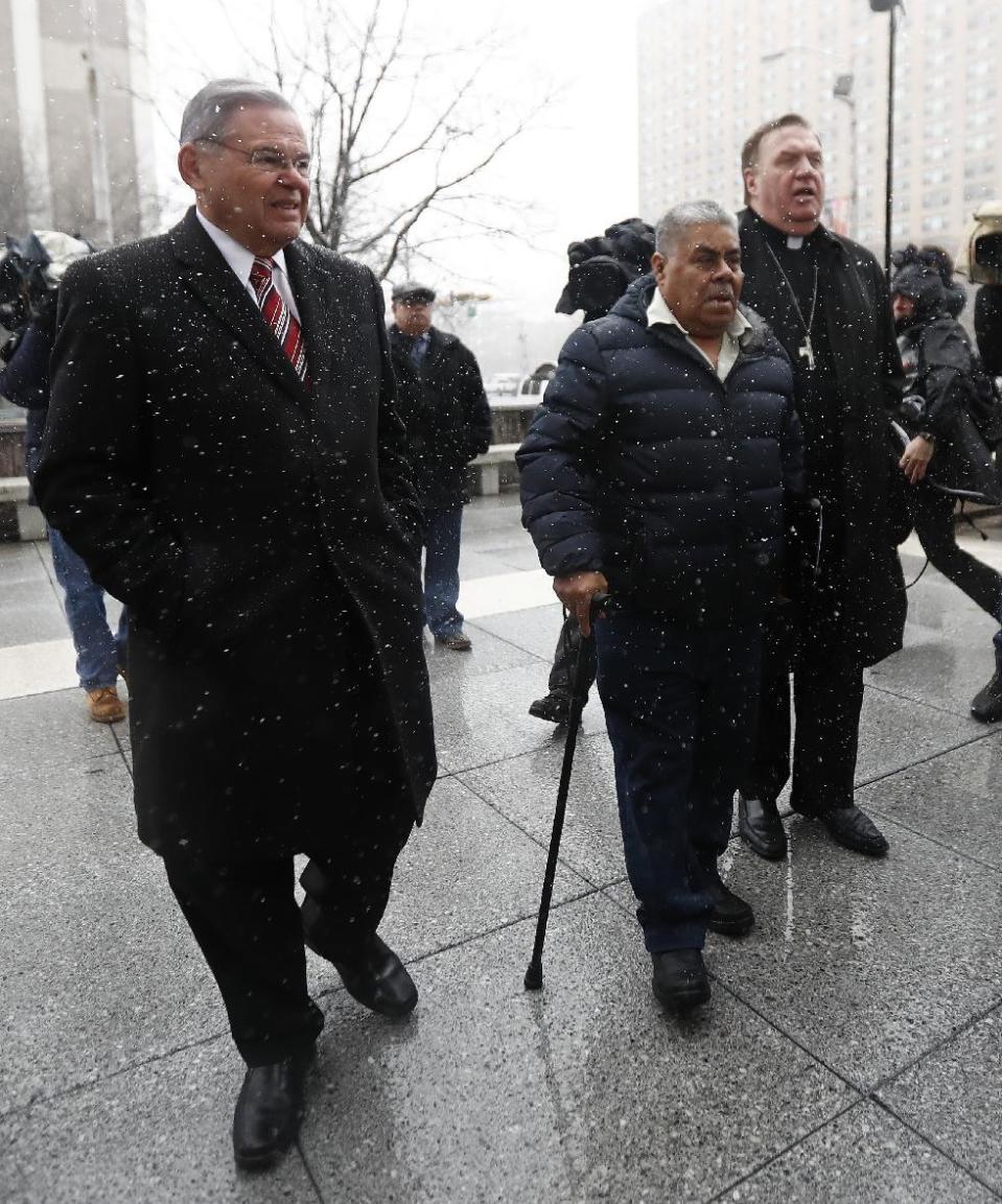 Catalino Guerrero, center, walks with U.S. Sen. Bob Menendez, left, and Newark Archbishop Cardinal Joseph Tobin, right, during a rally outside of the Peter Rodino Federal Building before attending an immigration hearing, Friday, March 10, 2017, in Newark, N.J. Guerrero, who arrived in the U.S. illegally in 1991, is facing deportation. Organizers claim he is an upstanding citizen and should not be deported. (AP Photo/Julio Cortez)