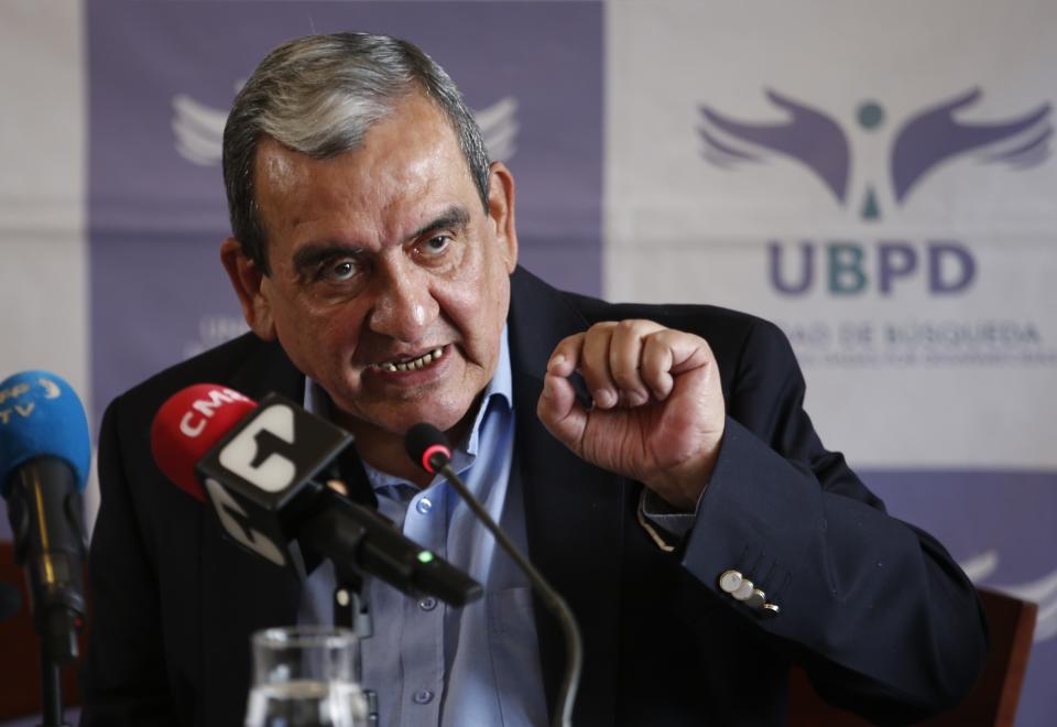 Jaime Alberto Parra, an ex-combatant of the Revolutionary Armed Forces of Colombia, FARC, speaks during a presentation on information on those disappeared during the nation's civil conflict, in Bogota, Colombia, Tuesday, Aug. 20, 2019. A special unit tasked by Colombia’s peace process to search for the thousands who disappeared over more than five decades of conflict will analyze the information and work with authorities to try and locate remains. (AP Photo/Fernando Vergara)