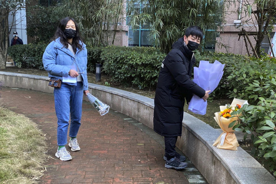 Residents visiting the Wuhan Central Hospital offer flowers in memory of Li Wenliang, the whistleblower doctor who sounded the alarm and was reprimanded by local police for it in the early days of Wuhan's pandemic, prior to the anniversary of his death, in central China's Hubei province, Saturday, Feb. 6, 2021. Dr. Li Wenliang died in the early hours of Feb. 7 from the virus first detected in this Chinese city. A small stream of people marked the anniversary at the hospital. The 34-year-old became a beloved figure and a potent symbol in China after it was revealed that he was one the whistleblowers who authorities had punished early for “spreading rumors” about a SARS-like virus. (AP Photo/Ng Han Guan)