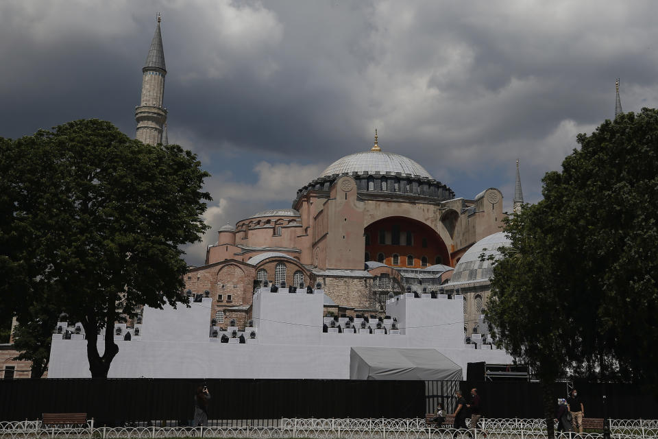 A view of a ''wall' set in front of Istanbul's 6th-century Hagia Sophia, the main cathedral of the Byzantine Empire which was converted into a mosque with the Ottoman conquest of the city, then known as Constantinople, in 1453, that was to be used as a set for the celebrations to mark the 567th anniversary of the conquest in Istanbul, Friday, May 29, 2020. A Muslim cleric recited the "prayer conquest" from the Quran inside the Hagia Sophia. Muslim prayers at the UNESCO World Heritage site are highly controversial, hitting at the heart of the country's religious-secular divide. (AP Photo/Emrah Gurel)