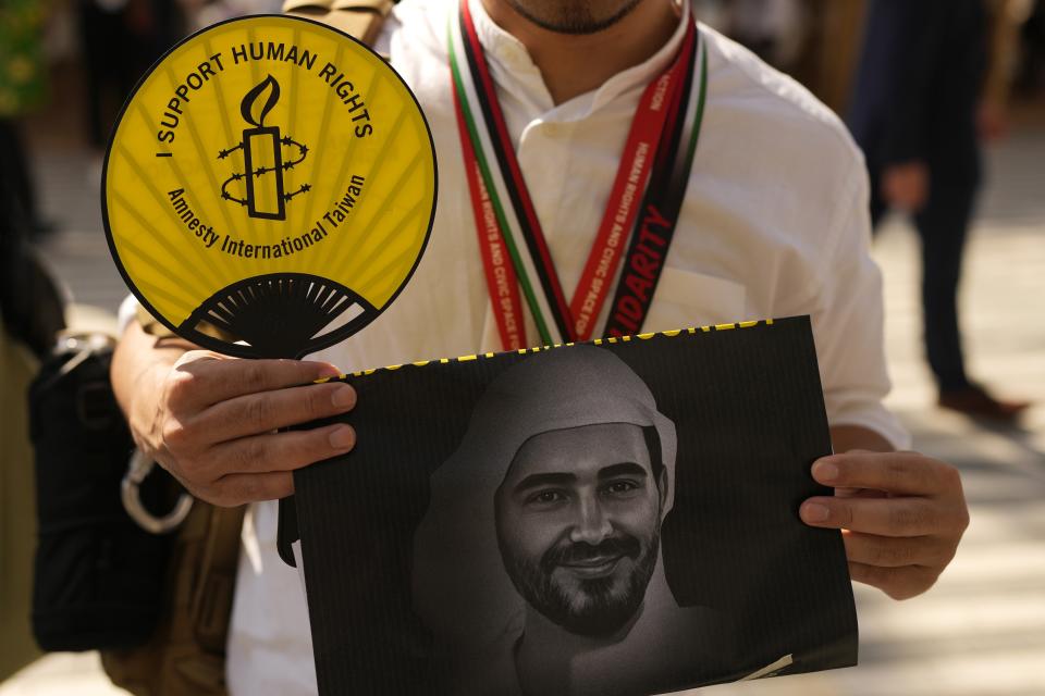 An activist holds a sign as they participate in a demonstration with the image of jailed activist Mohamed al-Siddiq at the COP28 U.N. Climate Summit, Saturday, Dec. 9, 2023, in Dubai, United Arab Emirates. (AP Photo/Rafiq Maqbool)