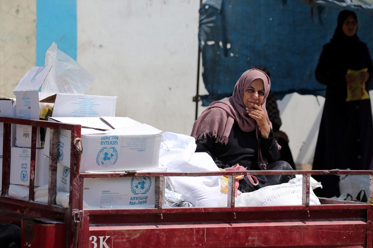 A Palestinian woman sits in a United Nations vehicle loaded with aid supplies in Gaza Strip: Reuters/Ibraheem Abu Mustafa