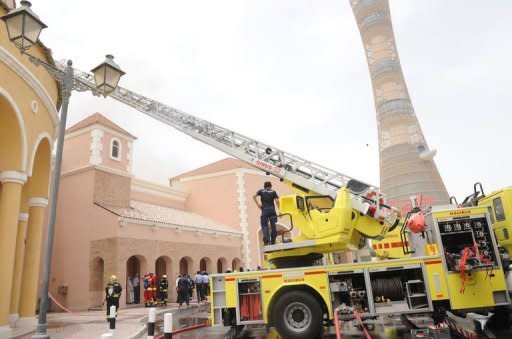 Qatari firefighters and rescue teams work outside Doha's Villagio Mall after a fire broke out at the Gulf emirate's main shopping centre on May 28, killing at least 19 people, including 13 children, and two members of the civil defence