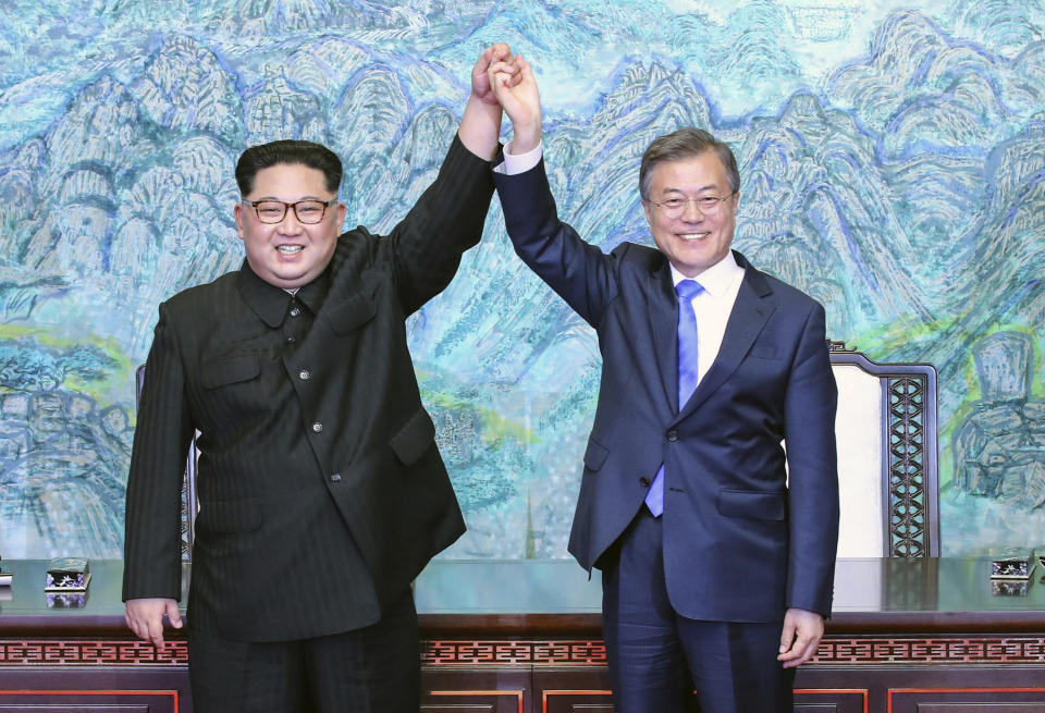 FILE - In this April 27, 2018 file photo, North Korean leader Kim Jong Un, left, and South Korean President Moon Jae-in raise their hands after signing a joint statement at the border village of Panmunjom in the Demilitarized Zone, South Korea. South Korea’s liberal president faces growing skepticism at home about his engagement policy ahead of his third summit with North Korean leader Kim Jong Un. A survey showed nearly half of South Koreans think next week’s summit won’t find a breakthrough to resolve a troubled nuclear diplomacy. It comes as Moon’s approval rating is declining amid economic frustrations. (Korea Summit Press Pool via AP, File)