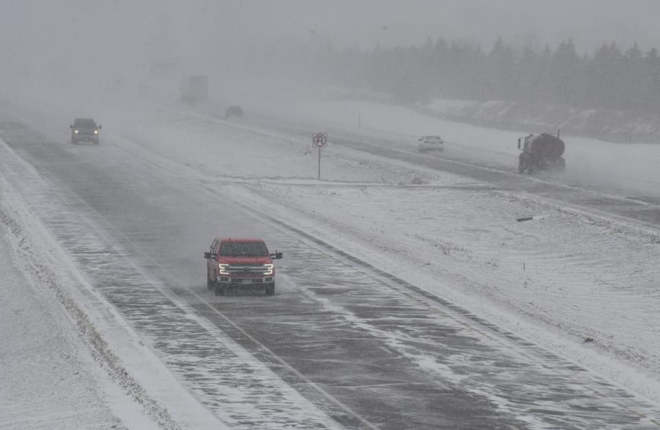 Traffic moves along Minnesota Highway 15 as snow begins to fall Monday, Feb. 21, 2022, in St. Cloud. 