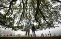 Golf patrons wander the foggy grounds during player practice rounds ahead of the 2015 Masters at Augusta National Golf Course in Augusta, Georgia April 8, 2015. REUTERS/Mark Blinch