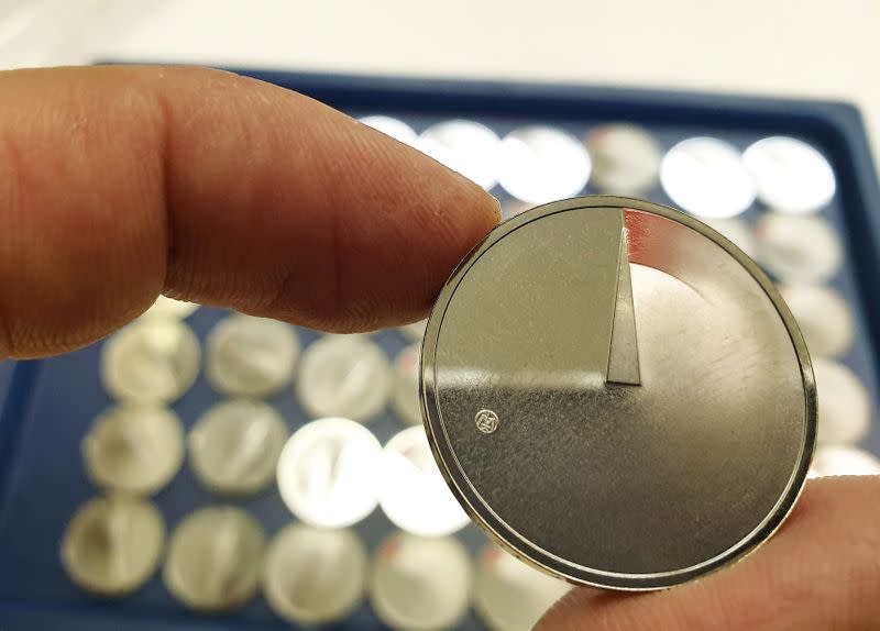 A man shows 5 Euros nominal silver coins, minted to mark the coronavirus disease (COVID-19) outbreak in Vilnius