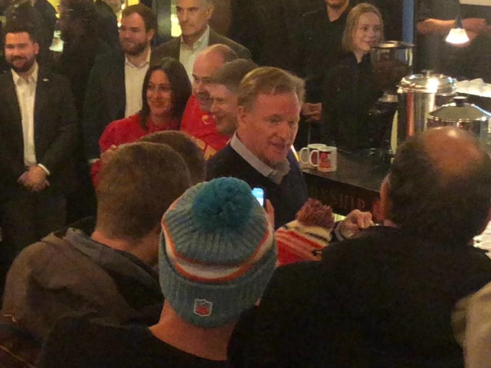 Kansas City Chiefs owner Clark Hunt poses for a photo with Chiefs fans while NFL commissioner Roger Goodell helps serve drinks on the 250-foot “ChampionShip” boat docked on The Main River on Saturday night in Frankfurt, Germany.