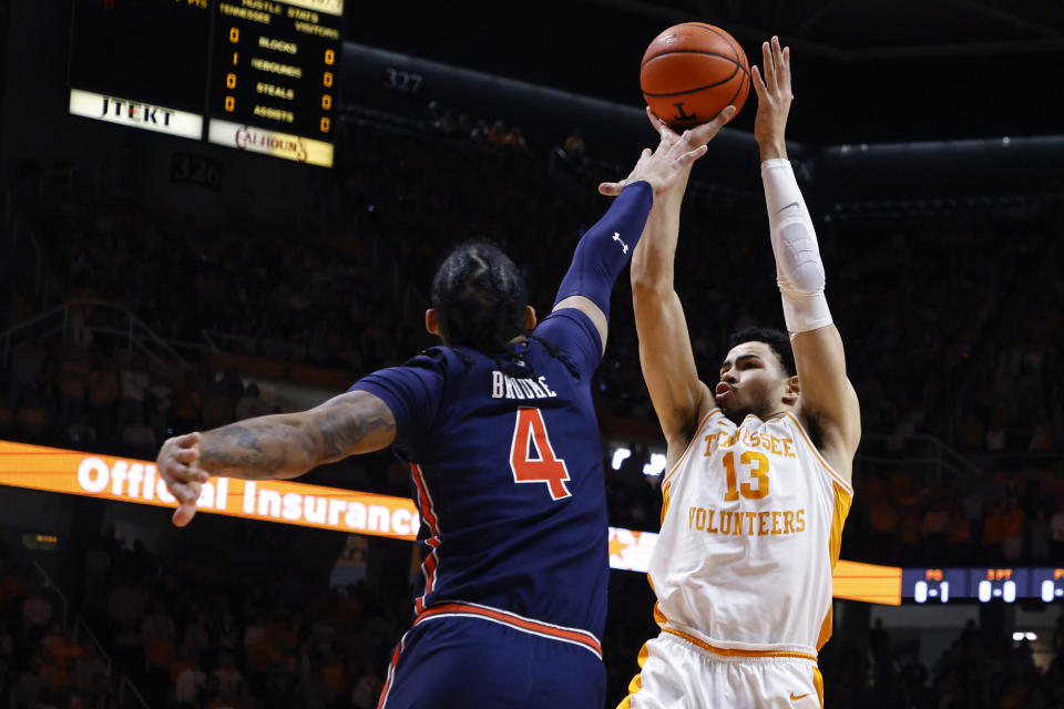 Tennessee forward Olivier Nkamhoua (13) shoots over Auburn forward Johni Broome (4) during the first half of an NCAA college basketball game Saturday, Feb. 4, 2023, in Knoxville, Tenn. (AP Photo/Wade Payne)