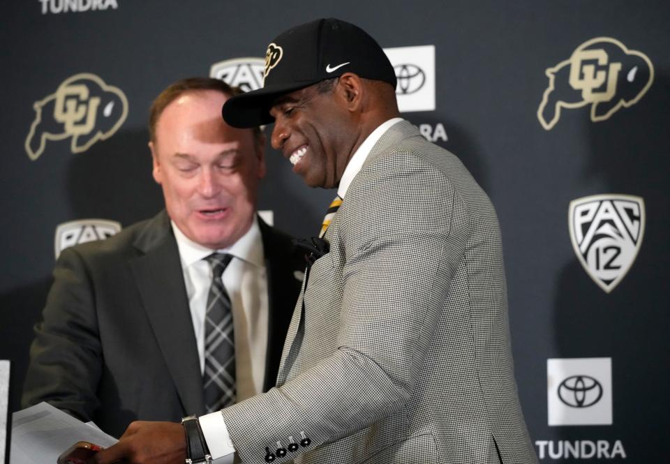 Deion Sanders, front, is welcomed to the podium by Colorado atheltic director Rick George, a former Vanderbilt associate AD, after introducing Sanders as the new football coach at Colorado Dec. 4, 2022, in Boulder, Colo. (AP Photo/David Zalubowski)
(Photo: The Associated Press)