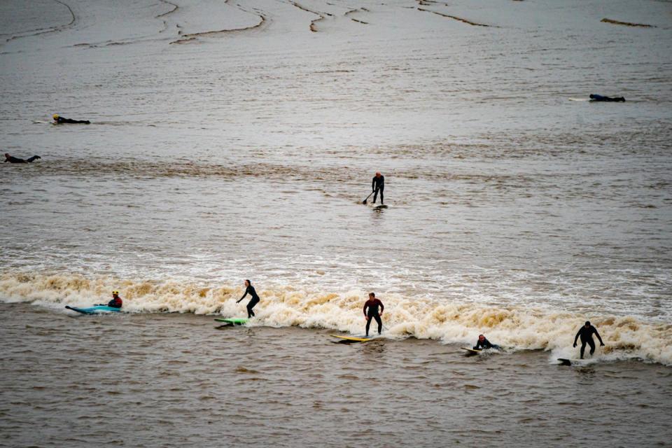 Surfers ride the first ‘five-star’ bore of 2024 at Newnham, Gloucestershire (PA)