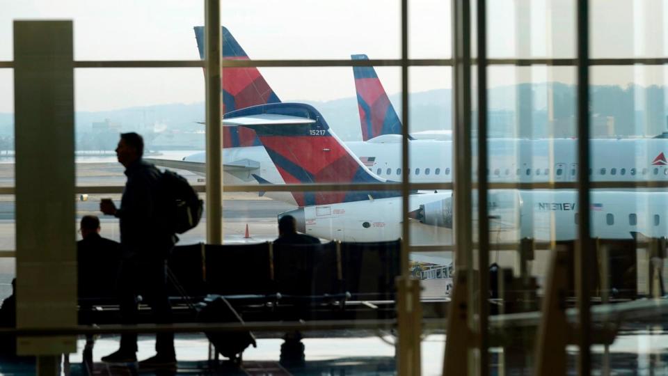 PHOTO: A person walks through the terminal as planes remain at gates at Ronald Reagan Washington National Airport in Arlington, Va., Wednesday, Jan. 11, 2023. (Patrick Semansky/AP, FILE)