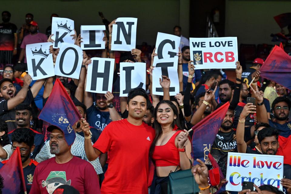 Royal Challengers Bangalore's team fans cheer before the start of the Indian Premier League (IPL) Twenty20 cricket match between Royal Challengers Bangalore and Lucknow Super Giants at the M Chinnaswamy Stadium in Bengaluru on April 10, 2023. (Photo by Manjunath KIRAN / AFP) (Photo by MANJUNATH KIRAN/AFP via Getty Images)