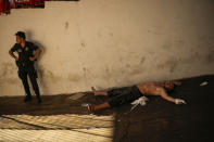 An exhausted wrestler lies on the ground after competing during the 661st annual Historic Kirkpinar Oil Wrestling championship, in Edirne, northwestern Turkey, Saturday, July 2, 2022. The festival is part of UNESCO's List of Intangible Cultural Heritages. (AP Photo/Francisco Seco)