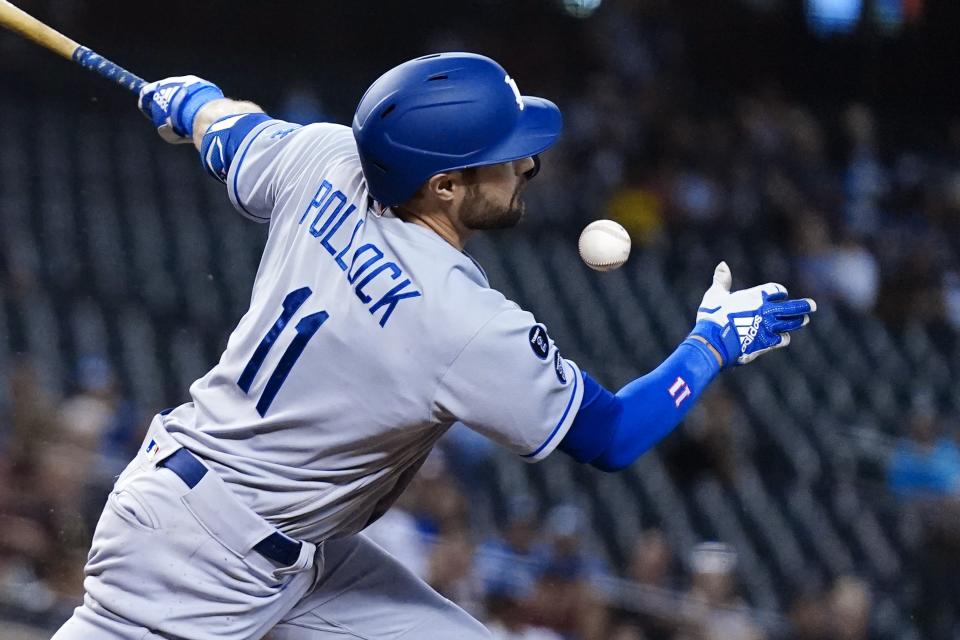 Los Angeles Dodgers' AJ Pollock fouls a ball off his face during the first inning of a baseball game against the Arizona Diamondbacks Sunday, Sept. 26, 2021, in Phoenix. (AP Photo/Ross D. Franklin)