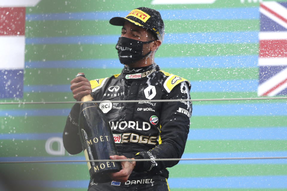 Third place Renault driver Daniel Ricciardo of Australia celebrates on the podium after the Eifel Formula One Grand Prix at the Nuerburgring racetrack in Nuerburg, Germany, Sunday, Oct. 11, 2020. (AP Photo/Matthias Schrader, Pool)