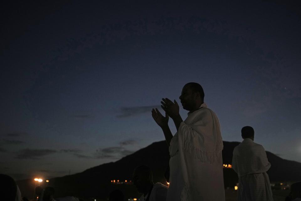 Muslim pilgrims pray on top of the rocky hill known as the Mountain of Mercy, on the Plain of Arafat, during the annual hajj pilgrimage, near the holy city of Mecca, Saudi Arabia, Friday, July 8, 2022. (AP Photo/Amr Nabil)