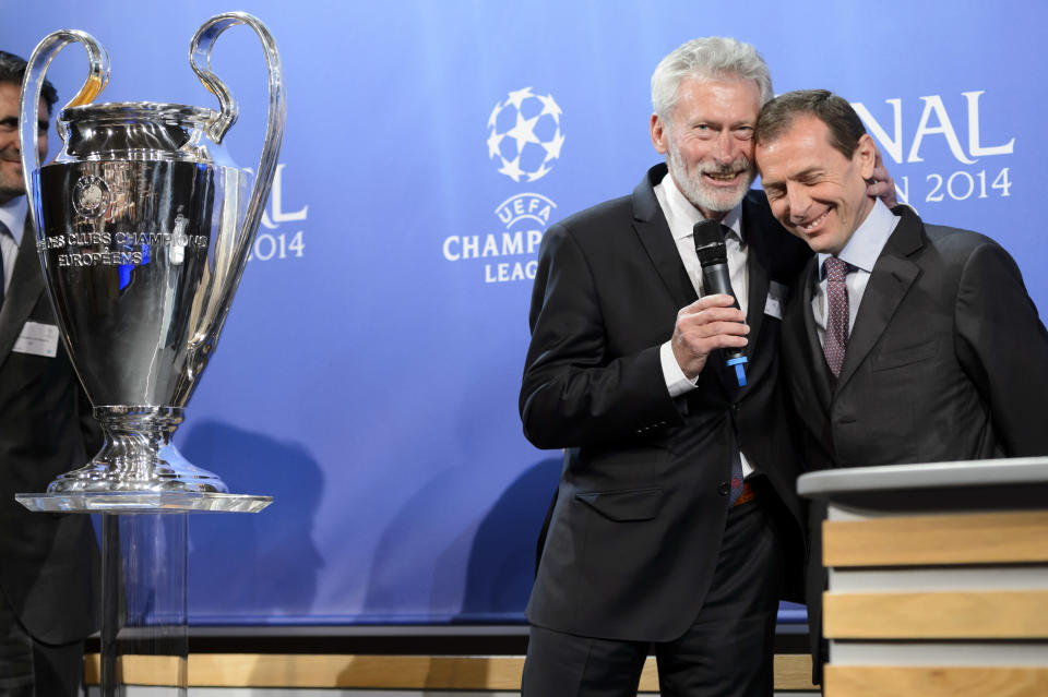 FC Bayern Muenchen club ambassador Paul Breitner, left, cheers with Real Madrid C.F. institutional Relations Director Emilio Butragueno, left, after the draw of the semi-finals of UEFA Champions League 2013/14 at the UEFA Headquarters in Nyon, Switzerland, Friday, April 11, 2014. (AP Photo/Keystone/Laurent Gillieron)