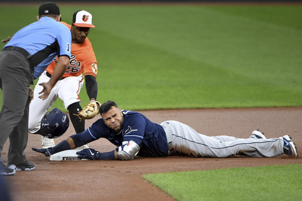 Tampa Bay Rays' Nelson Cruz slides safely in to second base in front of the tag of Baltimore Orioles second baseman Jorge Mateo on a double during the first inning of a baseball game Saturday, Aug. 7, 2021, in Baltimore. (AP Photo/Will Newton)