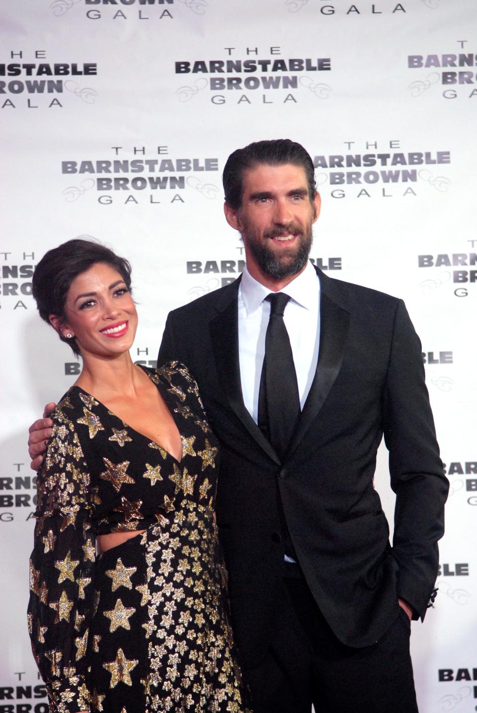 Model Nicole Johnson and her husband Olympic swimmer Michael Phelps pose for a photo on the red carpet at the Barnstable Brown Derby Eve Gala Friday night.