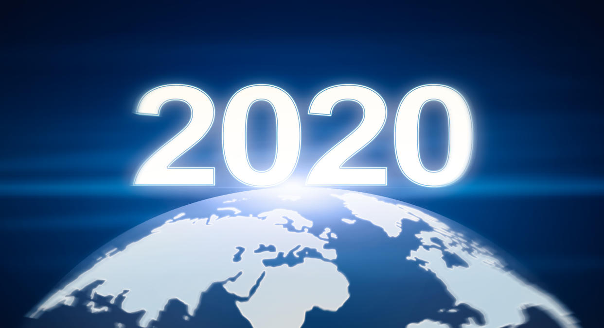 New Year coming concept. Planet Earth with glowing numbers 2020 like sunrise, panorama