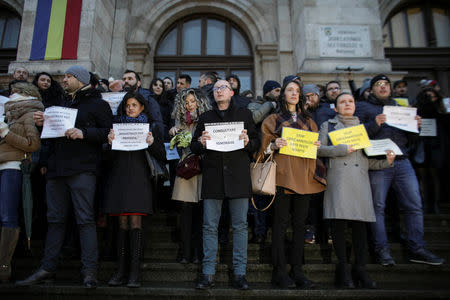 Magistrates display messages that read "Magistrates can protest", "Consultation does not mean ignoring" and "Stop the overnight changes to judicial legislation" during a protest against changes made to judicial legislation, in Bucharest, Romania, February 22, 2019. Inquam Photos/Octav Ganea via REUTERS