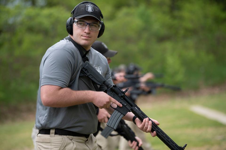 Kellogg Community College cadet Nick Cooper practices magazine changes at River Road Shooting Range in Battle Creek on Wednesday, May 18, 2022.
