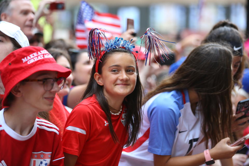 Fans celebrate as members of the U.S. women's soccer team pass by during a ticker tape parade along the Canyon of Heroes, Wednesday, July 10, 2019, in New York. (Photo: Gordon Donovan/Yahoo News)