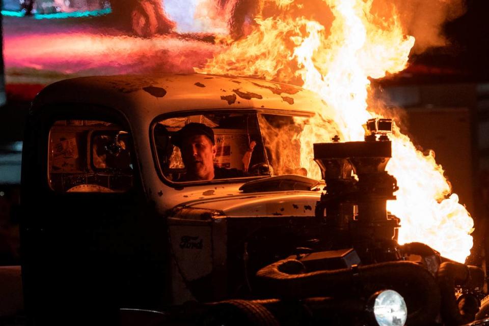 Phil Krantz, of Ordonville, Michigan, watches as his 1947 Ford catches on fire during a flame throwing competition, where drivers compete to see which car can produce the biggest flames, at Island View Casino in Gulfport during Cruisin’ The Coast on Tuesday, Oct. 3, 2023.