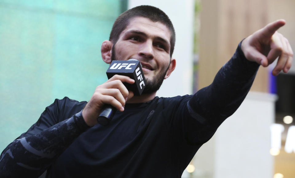 Russian UFC fighter Khabib Nurmagomedov gestures to the crowd during an open training session at Yas Mall in Abu Dhabi, United Arab Emirates, Wednesday, Sept. 4, 2019. Fighters Dustin Poirier and Khabib Nurmagomedov will face each other in UFC 242, which will be held Saturday, Sept. 7, 2019, in Abu Dhabi. Nurmagomedov did not spar during the open training, saying he was still trying to make weight for the bout. (AP Photo/Jon Gambrell)