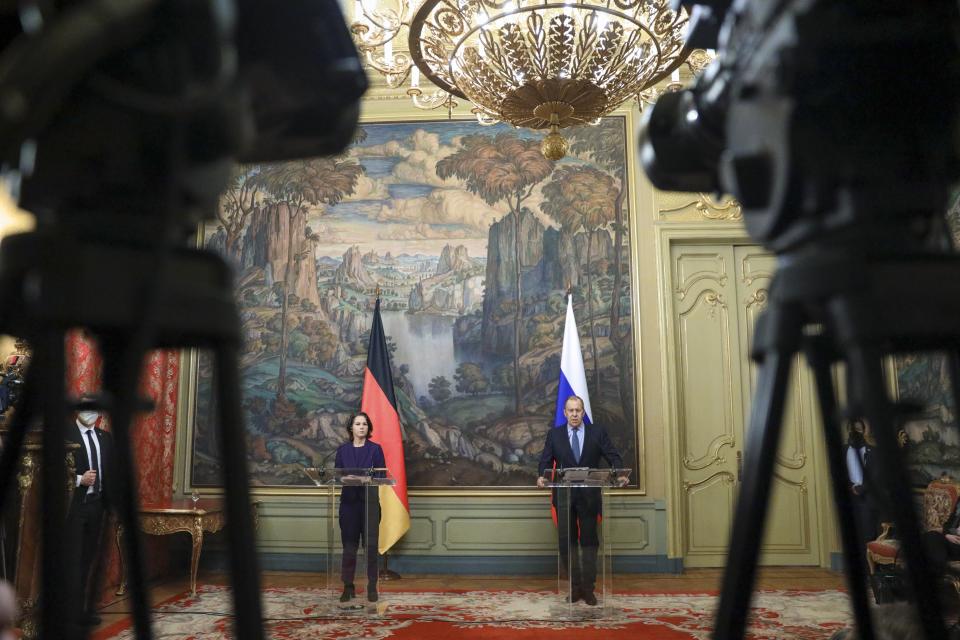 In this handout photo released by Russian Foreign Ministry Press Service, Russian Foreign Minister Sergey Lavrov and German Foreign Minister Annalena Baerbock attend a joint news conference following their talks in Moscow, Russia, Tuesday, Jan. 18, 2022. (Russian Foreign Ministry Press Service via AP)